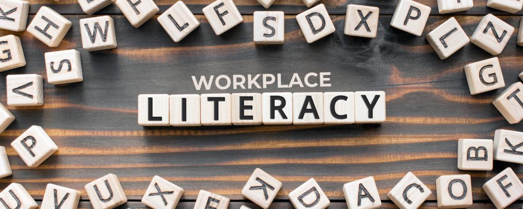 Image of lettered wooden blocks that spell out the words workplace literacy