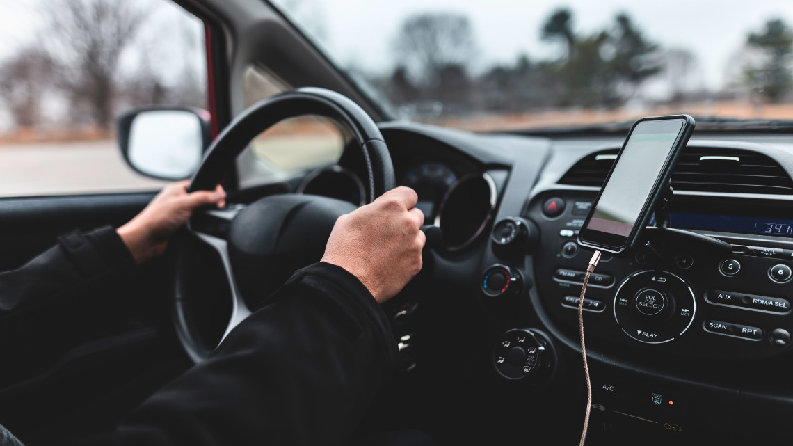 Image of person holding a steering wheel for driving safety