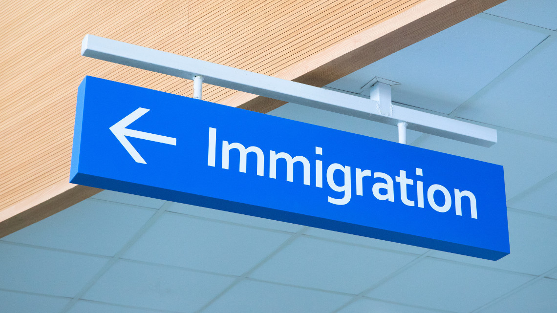 Directional sign with the word 'immigration' on it