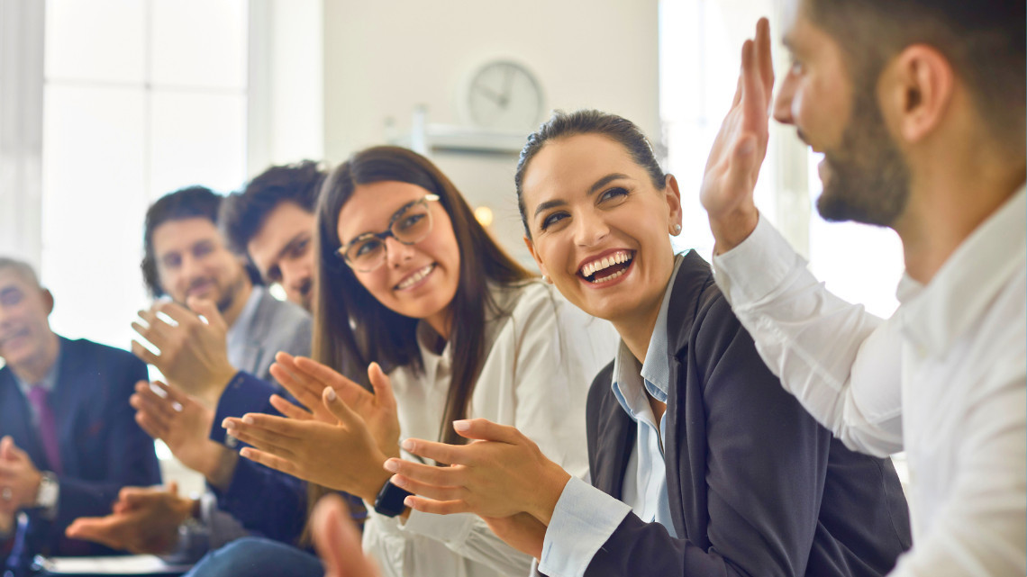 Group of people clapping for employee recognition
