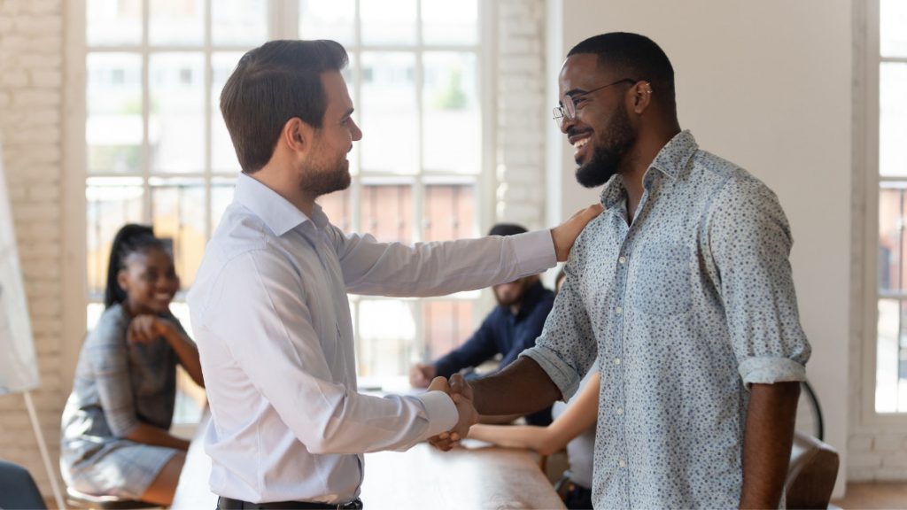 Two people shaking hands as likable bosses