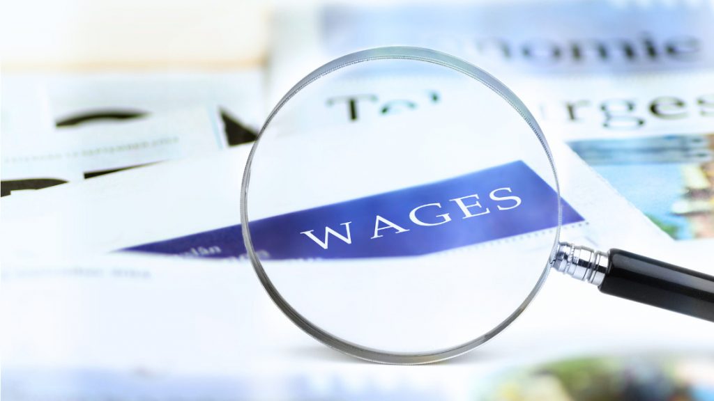 Magnifying glass hovering over the words minimum wage