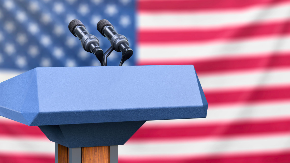 Image of a podium against an American flag background, representing post debate results