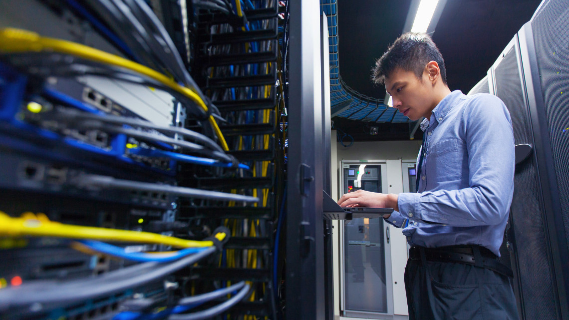 image of a person working inside a data center