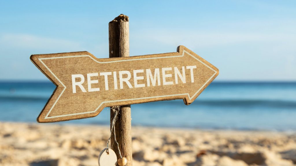 a retirement sign in the sand at a beach representing secure 2.0