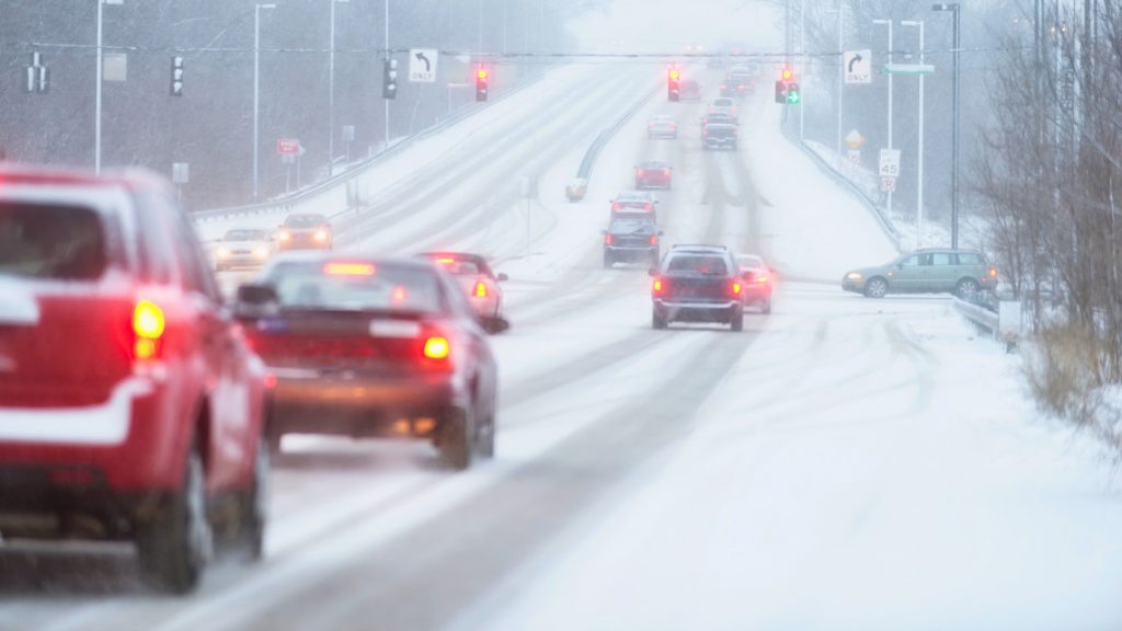 cars driving in severe winter weather