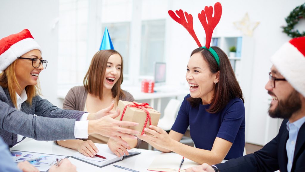 group of coworkers celebrating the holiday in an office setting