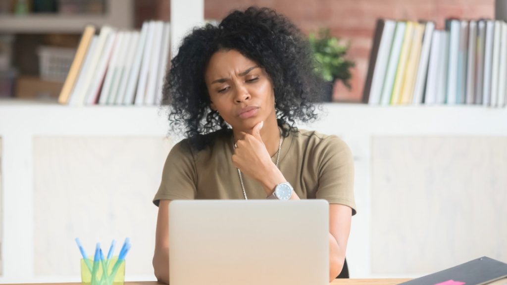 person sitting at a laptop, making decisions