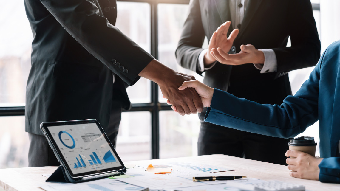 image of people shaking hands over talent acquisition