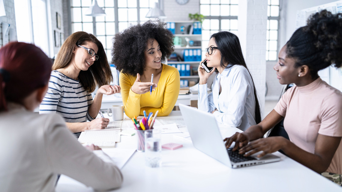 image of women in leadership around a conference table