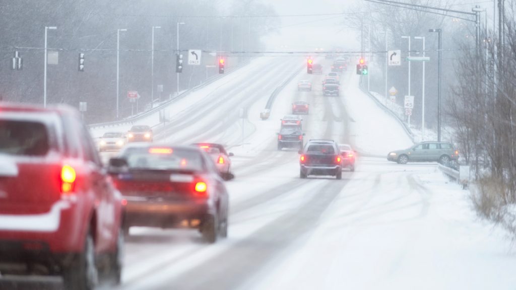 image of automobiles traveling roads in bad weather